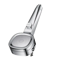 Chrome shower head with stop button.