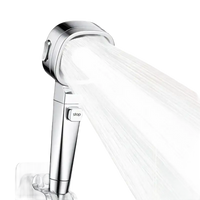 Chrome shower head with water stream.