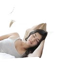 Sleeping woman on silk pillowcases.
