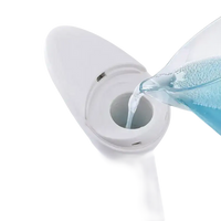 White automatic soap dispenser being filled.