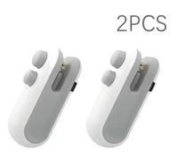 Two white and gray mini game controllers.