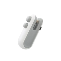 White and gray handheld sealing device.