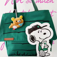 Green tote bag with Snoopy and bear charm.