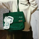 Green shoulder bag with Snoopy sticker.