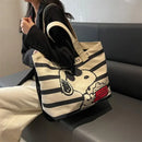 Striped tote bag with cartoon dog.