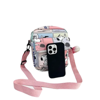 Snoopy cartoon crossbody bag with pink strap.