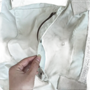 Beige jacket with pockets and zipper.