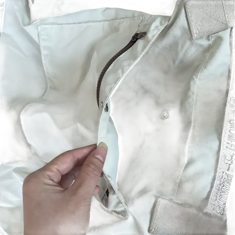 Beige jacket with pockets and zipper.