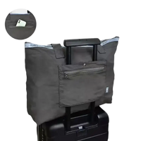 Gray tote bag on luggage.