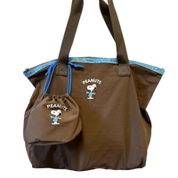 Brown tote bag with Snoopy design.