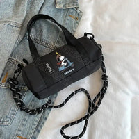 Black barrel-shaped Snoopy handbag.