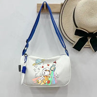 White shoulder bag with Snoopy astronaut design.