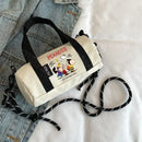 Peanuts-themed barrel bag with black straps.