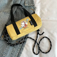 Yellow cylindrical handbag with cartoon astronaut.