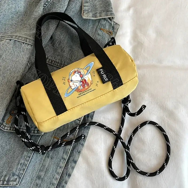 Yellow cylindrical handbag with cartoon astronaut.