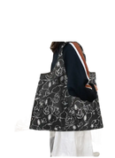 Black tote bag with Snoopy pattern.
