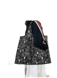 Black tote bag with Snoopy pattern.