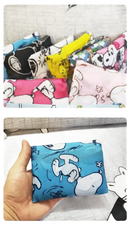 Colorful Snoopy-themed reusable shopping bags.