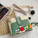 Canvas crossbody bag with cartoon characters.