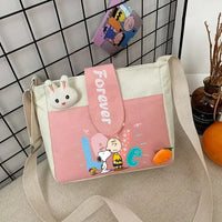 Pink and white cartoon-themed shoulder bag.