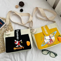 Two Snoopy-themed crossbody bags.