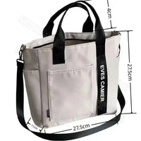 Gray tote bag with black straps.