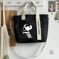 Black tote bag with Snoopy design.