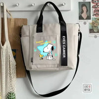 Beige tote bag with Snoopy design.