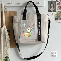 Beige tote bag with Snoopy astronaut design.