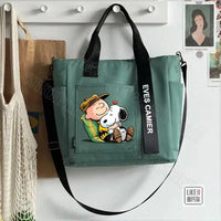 Green tote bag with Snoopy and Charlie Brown design.