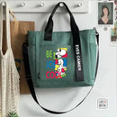 Green tote bag with Snoopy design.