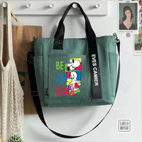 Green tote bag with Snoopy design.
