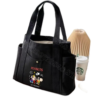 Black canvas tote bag with Peanuts characters.
