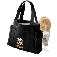 Black canvas tote bag with Snoopy design.