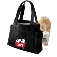 Black canvas tote bag with Snoopy design.