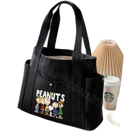 Black canvas tote bag with Peanuts characters.