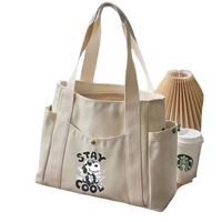Canvas tote bag with side pockets.