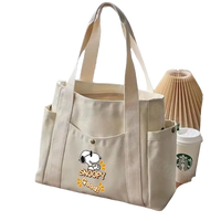 Beige canvas tote bag with Snoopy design.