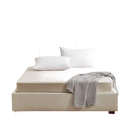 Beige upholstered bed with white pillows.