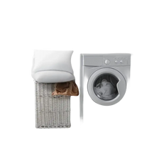 Washing machine next to laundry basket.