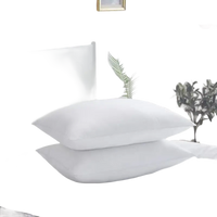 Stacked white pillows.