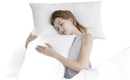 Sleeping woman hugging a pillow.