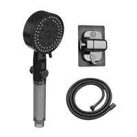 Black handheld shower head with hose and mount.
