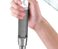 Handheld shower head with transparent body.