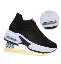 Black and white athletic shoe with springy sole.