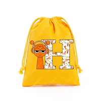 Yellow drawstring bag with cartoon graphics.