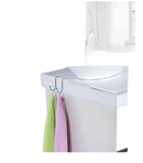 Toilet-mounted towel hooks with towels.