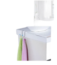 Toilet-mounted towel hooks with towels.