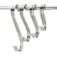 Four shiny metal S-hooks.