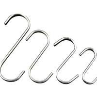 Four shiny metal S-hooks.